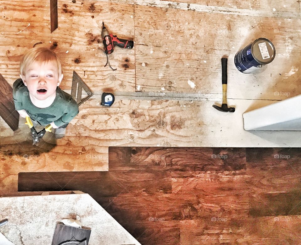 High angle view of a boy with carpentry tools