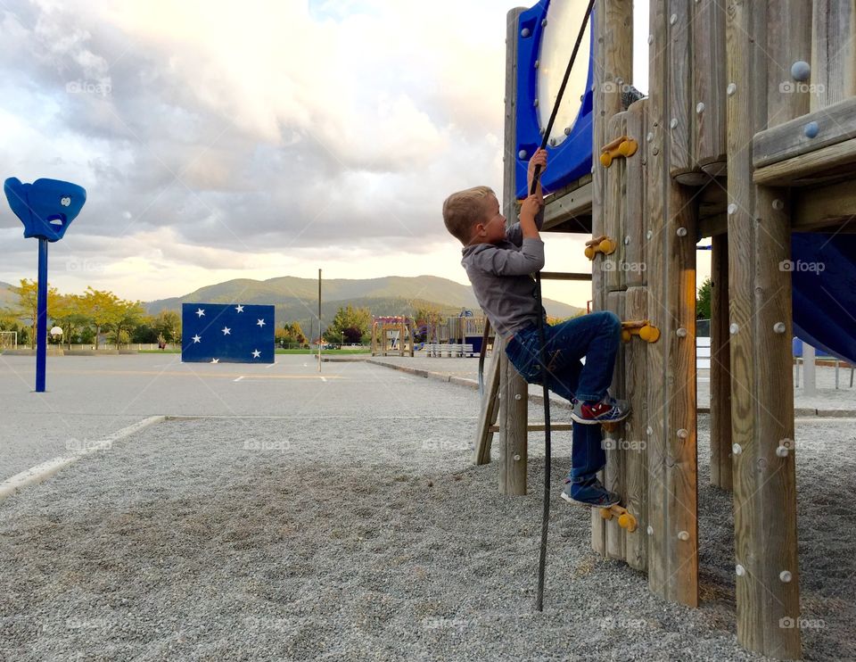 Boy climbing a rope 