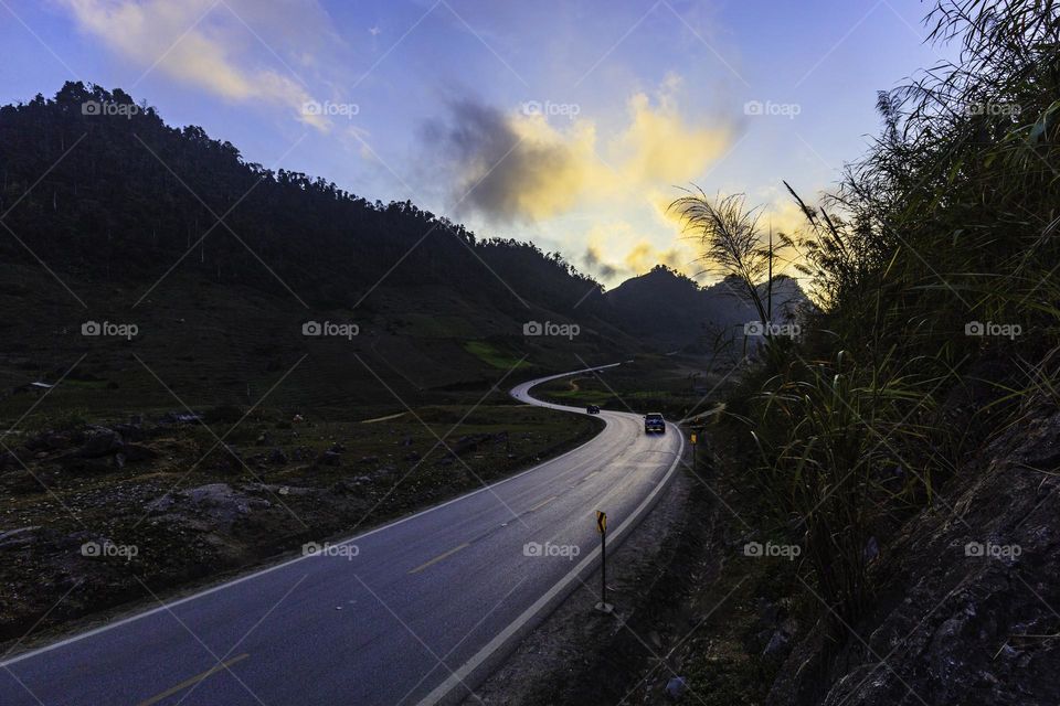 "S" road in sunset with dramatic sky