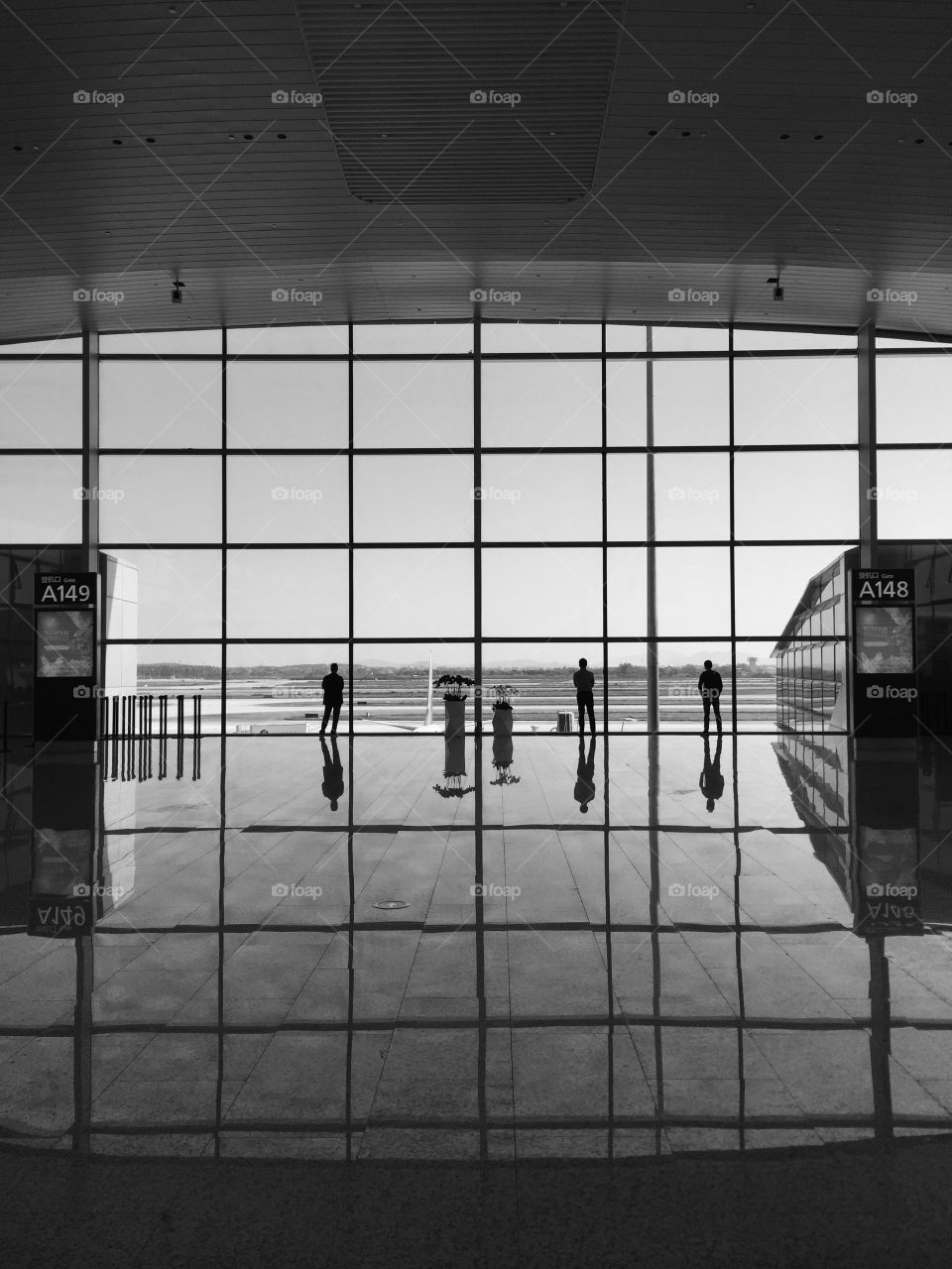 Travelers waiting at boarding gate in Guangzhou airport 