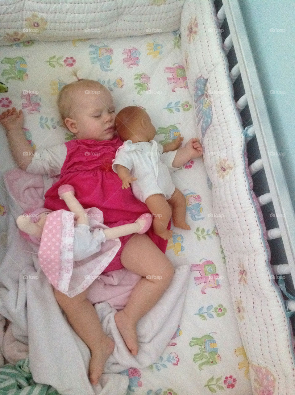 Sleeping baby loves her dolly