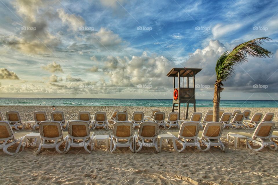 caribbean beach with chairs and shelter