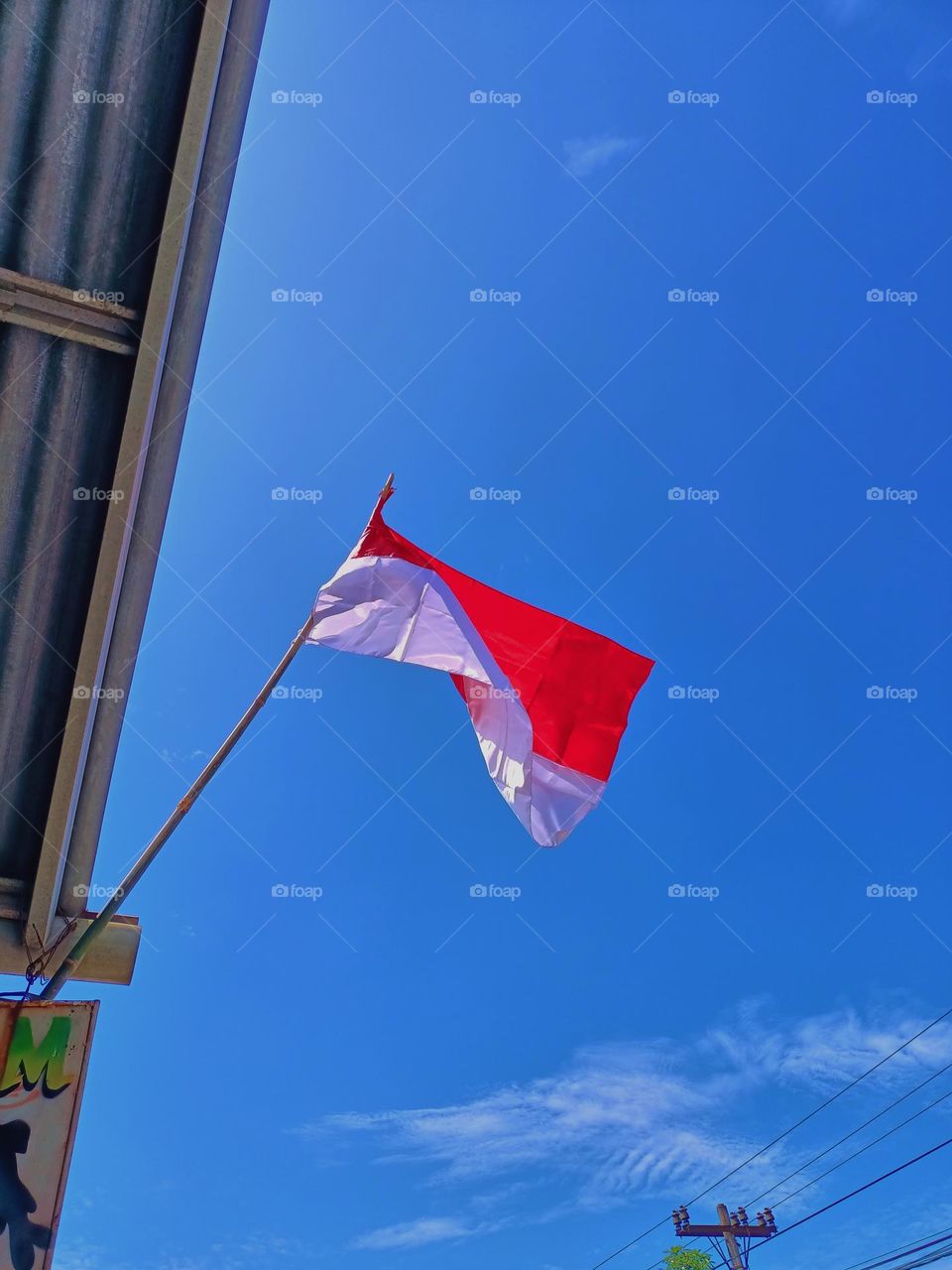 Red and white flag on a bamboo pole at the Indonesia's independence day