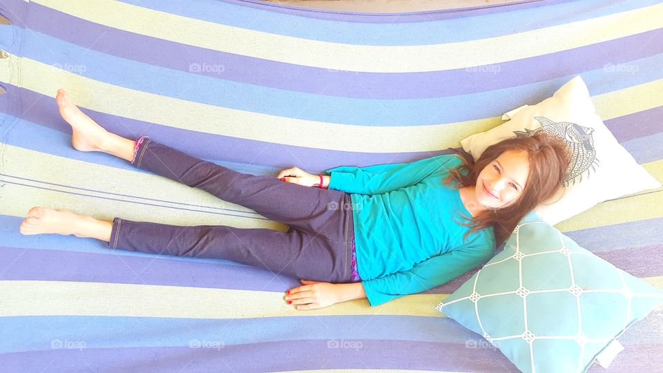 Girl laying on outdoor hammock