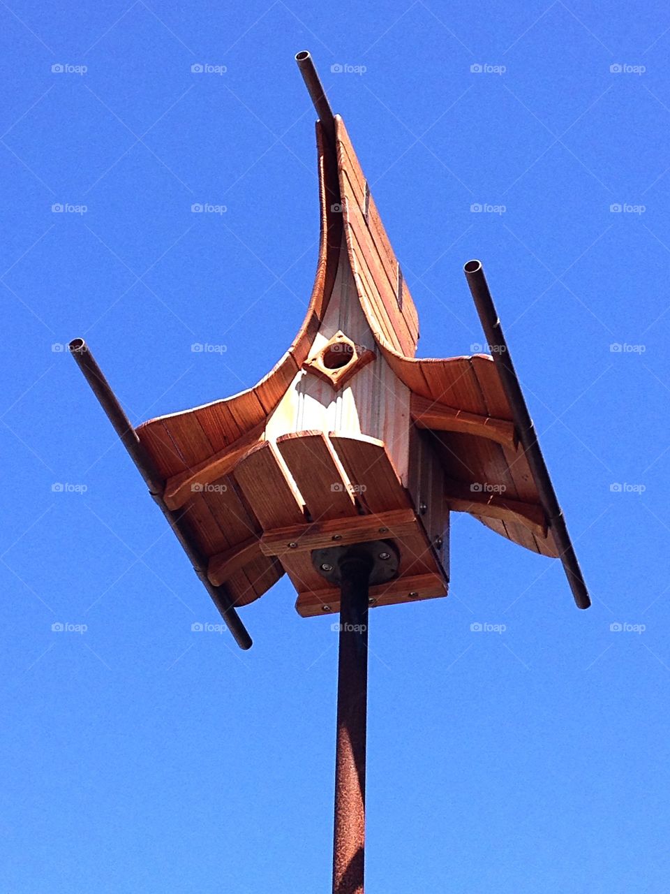 Birdhouse against a blue sky
