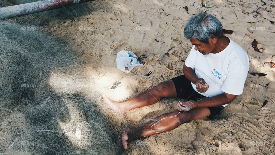 fisherman weaving net