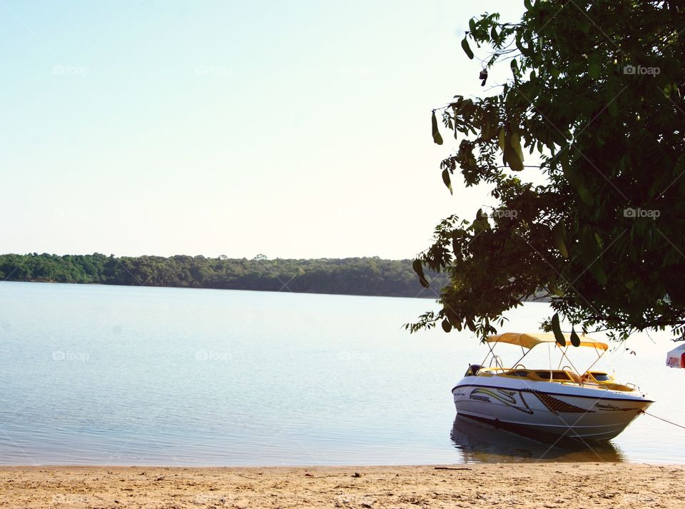 A boat floats on a peaceful river in Brazil 