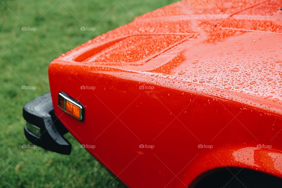 Close-up of red car in rain