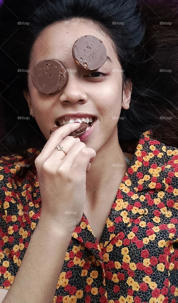 She is biting choco cookies