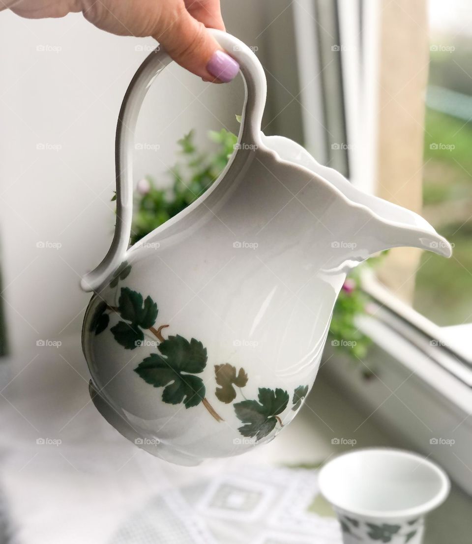 Vintage porcelain jug with grape leaf pattern