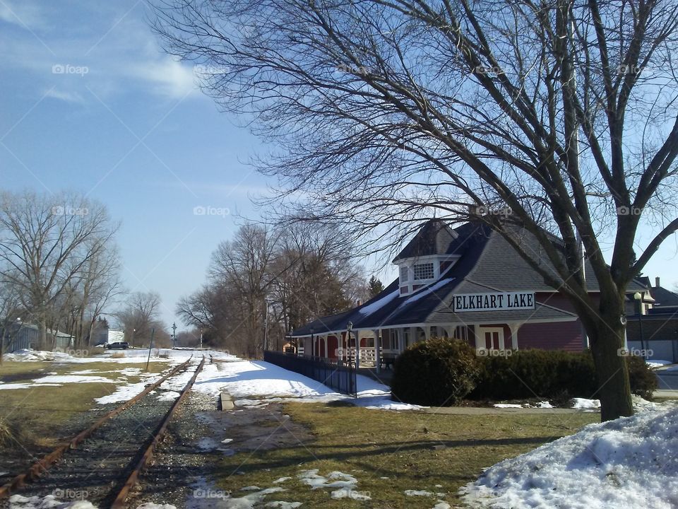 The snow is melting near the old train depot in the center of Elkhart Lake,Wisconsin on a very warm March Sunday afternoon.