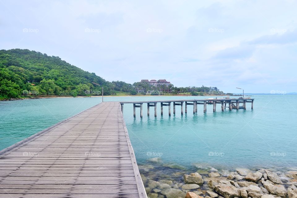 Wooden bridge extended into the sea at Kho Laem Ya national park Rayong, Thailand