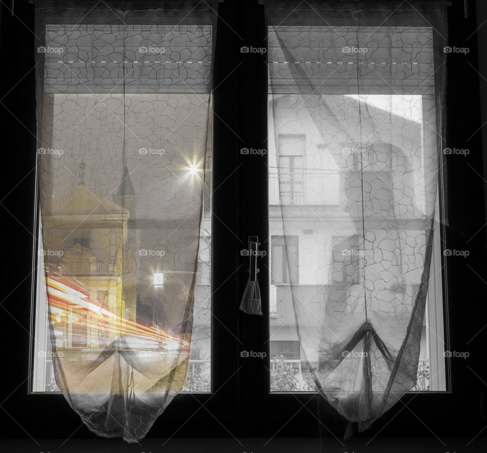 Man’s shadow looking through the window in the night, blur effect 