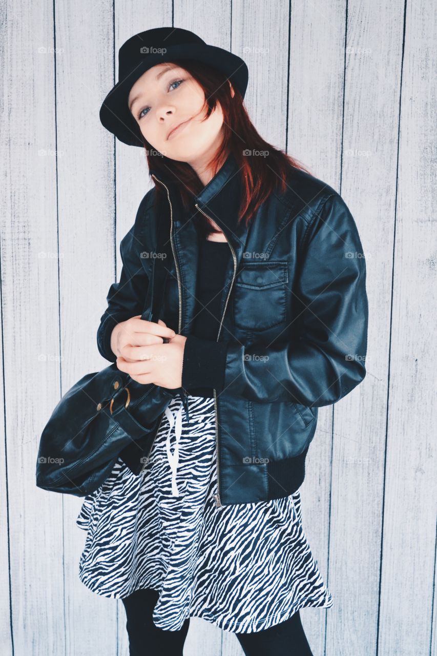 Girl in leather jacket and hat