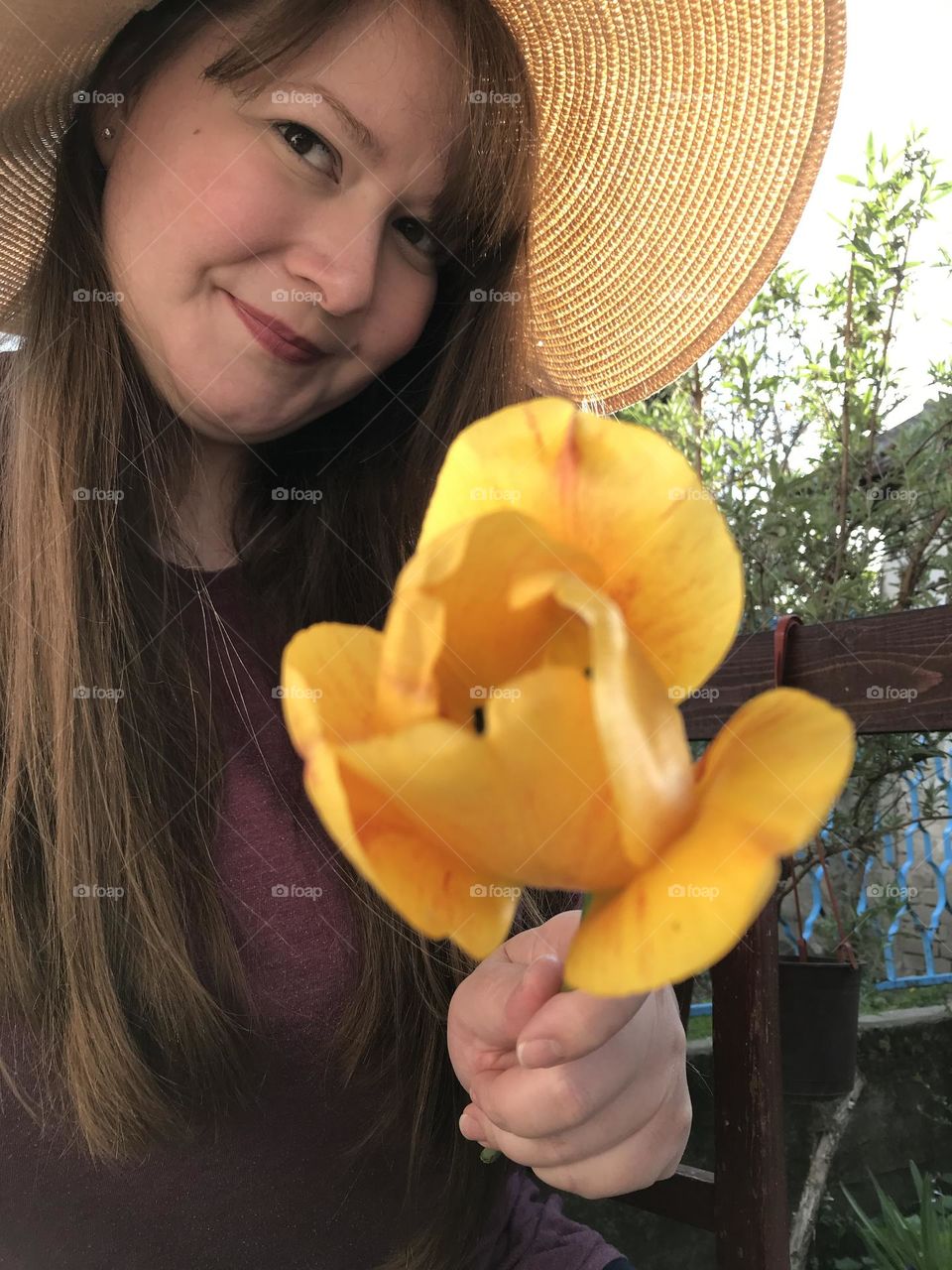 A girl with a yellow flower