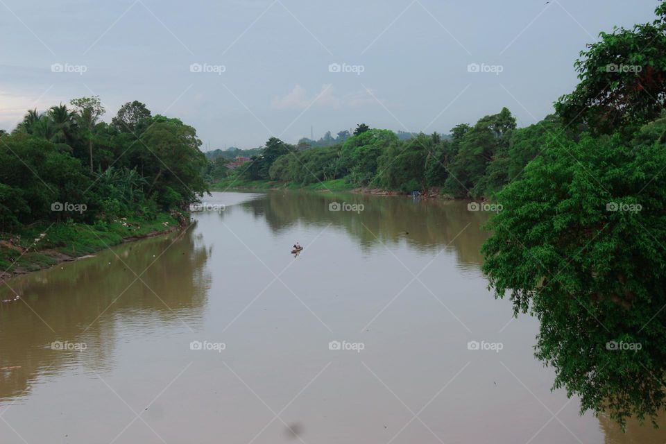 Above the river, which is long and deep, the water flows so cloudy that it looks very scary, even though the local people use the river for their daily needs.