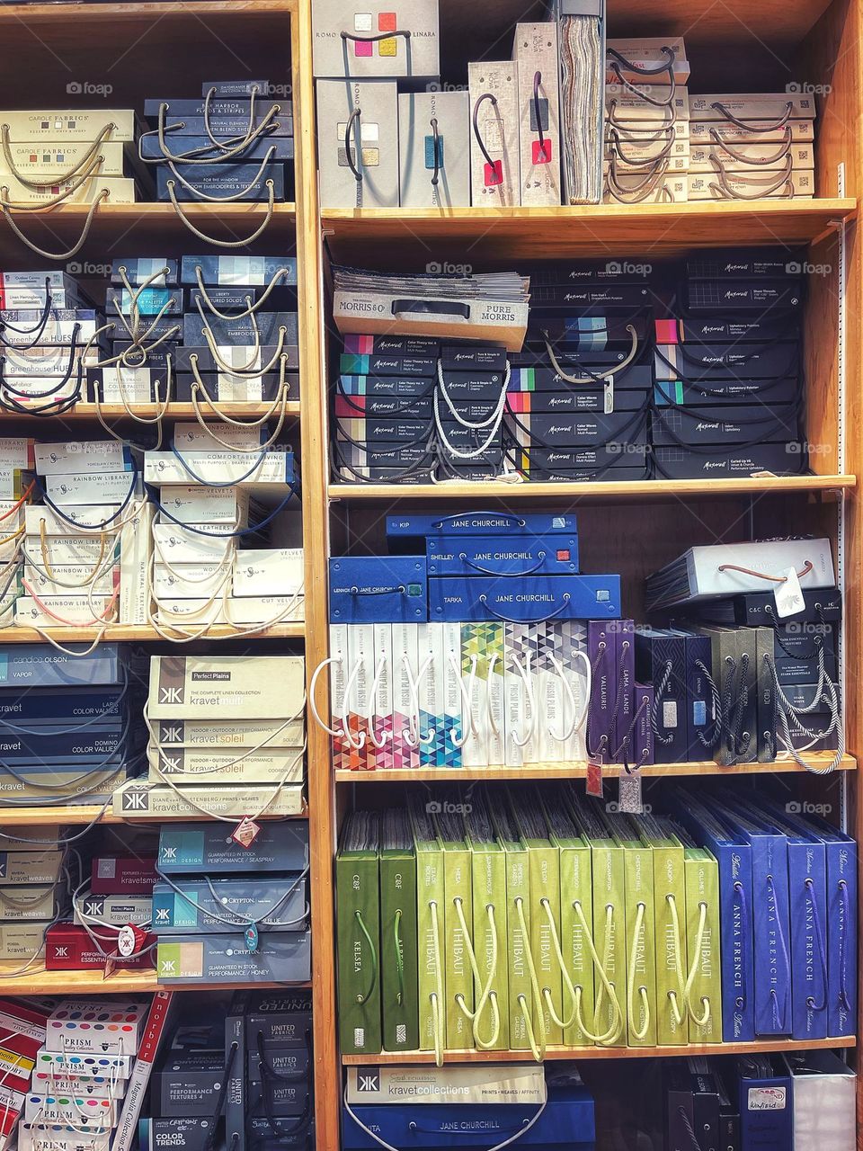 Shelves full of books of fabric at work 