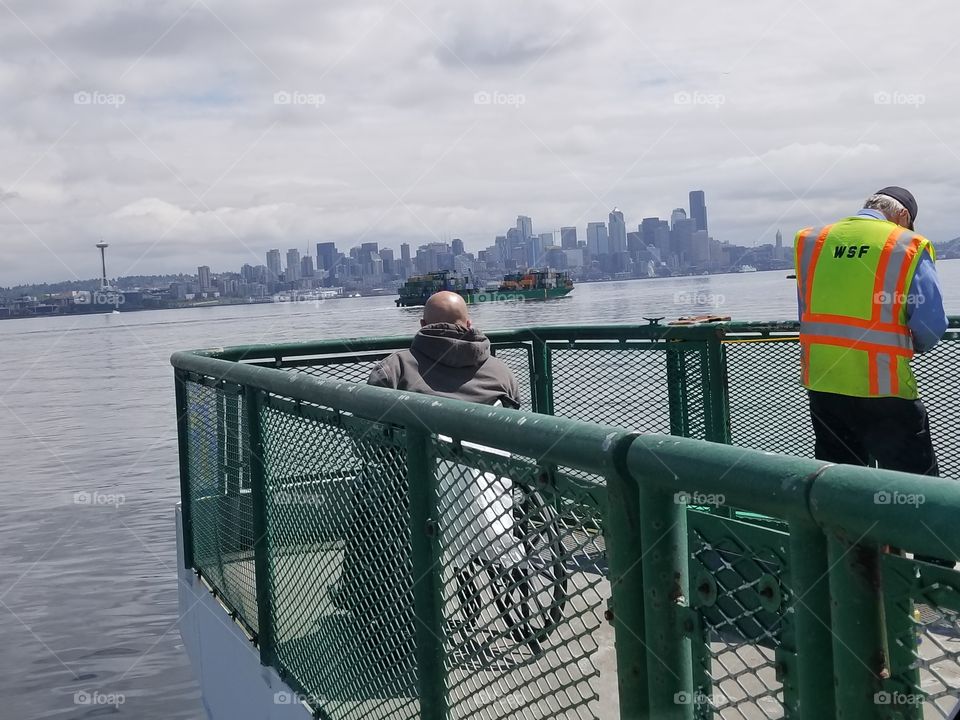Ferry Worker and Disabled on Deck of ferry to Seattle. Day in the life