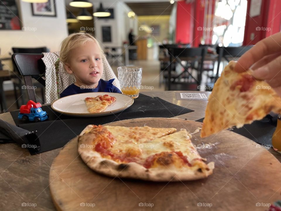 little girl in a pizza restaurant