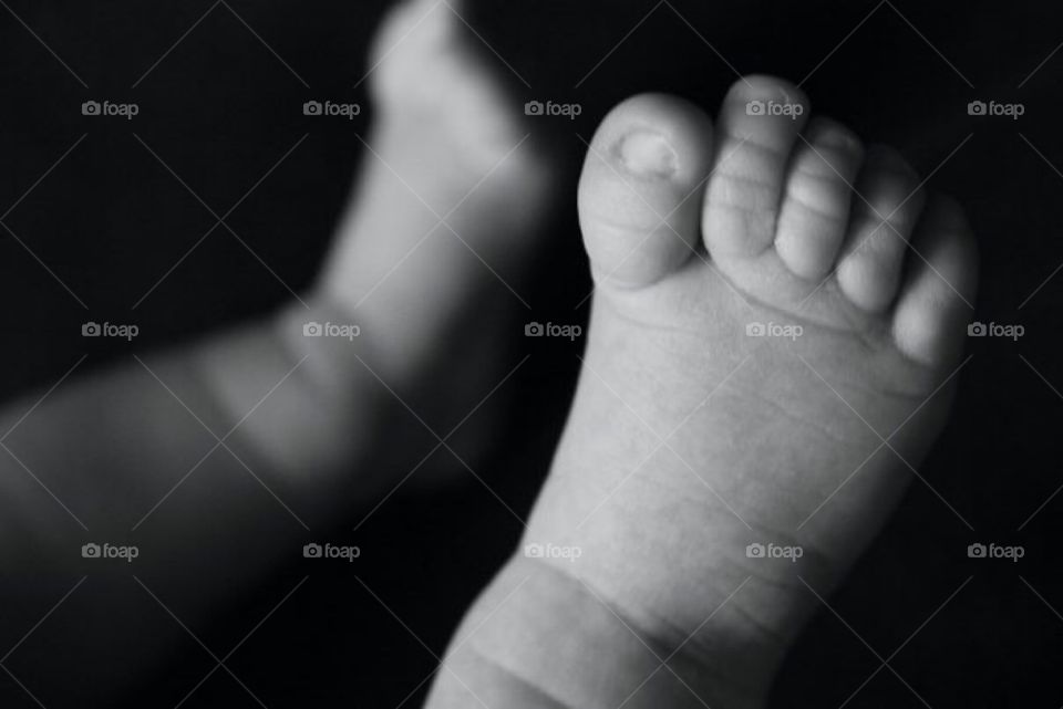 Black and white image of a new born baby's feet