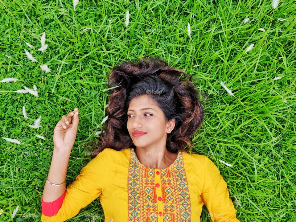 Girl lying down on the grass and enjoying