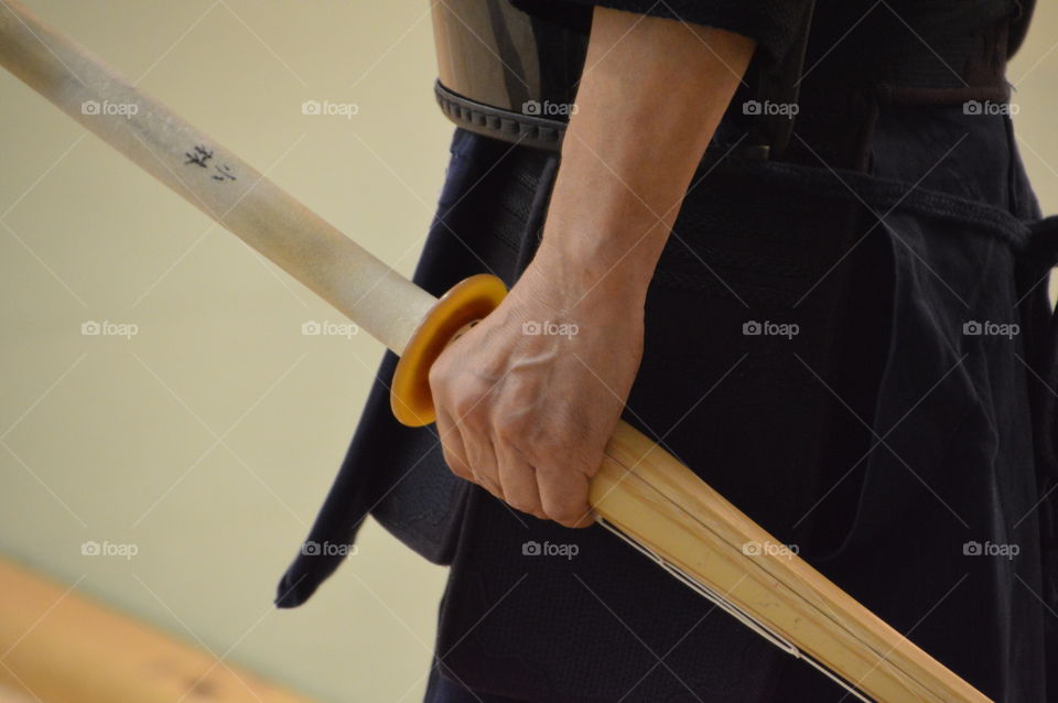 Japanese Man Holding Kendo Sword In His Hand