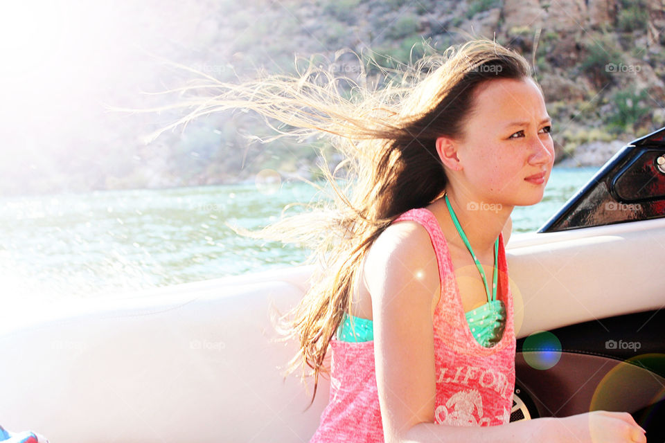 Close-up of a woman sitting in speed boat