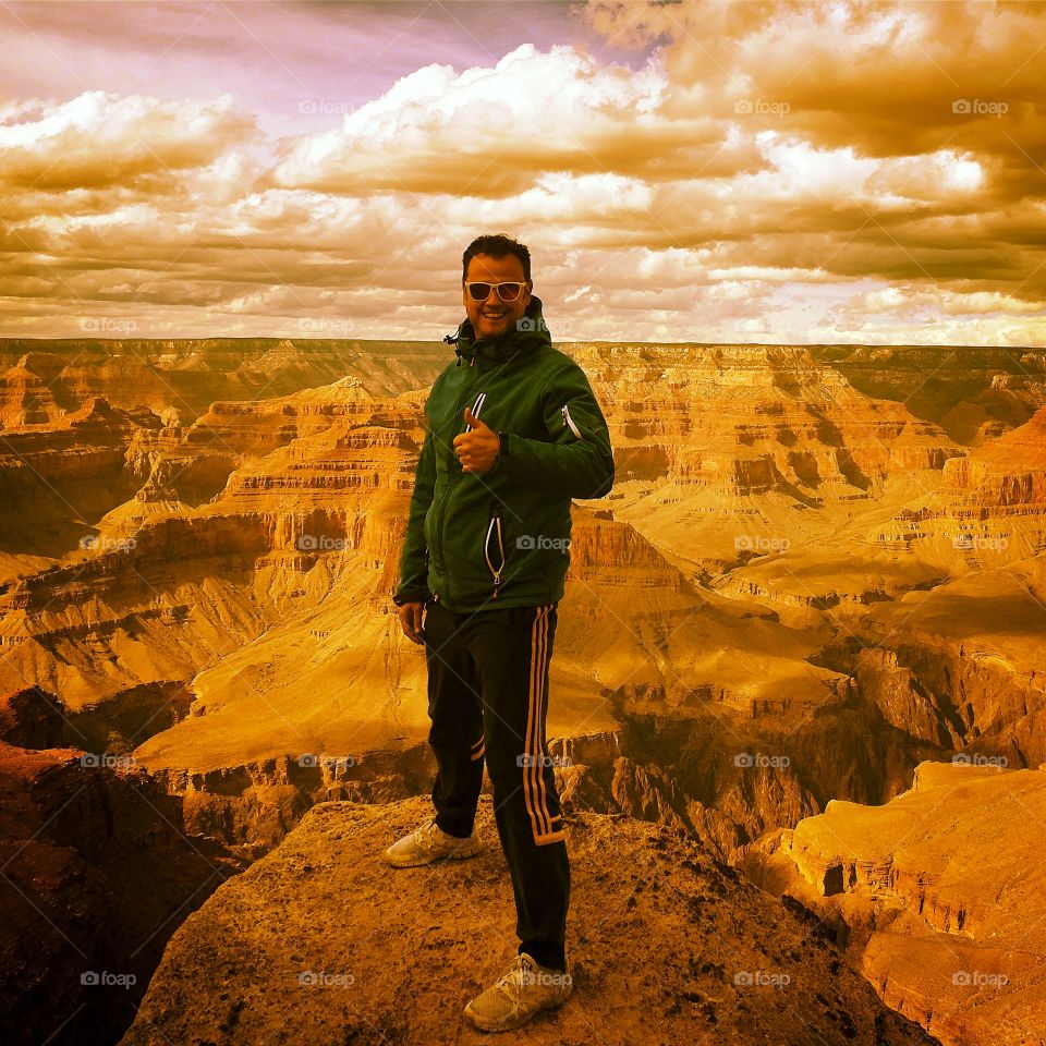 a man standing in a rock in the Grand Canyon