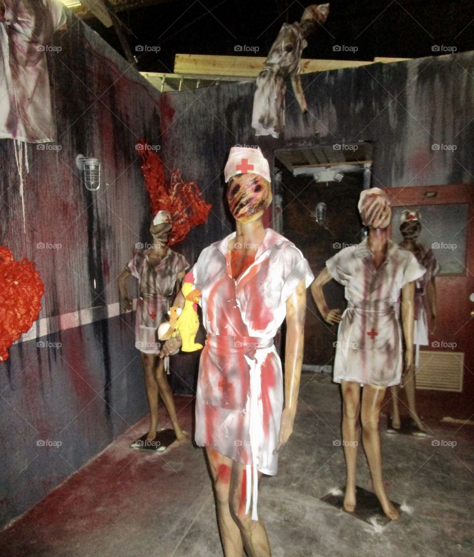 Bloody zombie nurses standing in a room of a haunted house