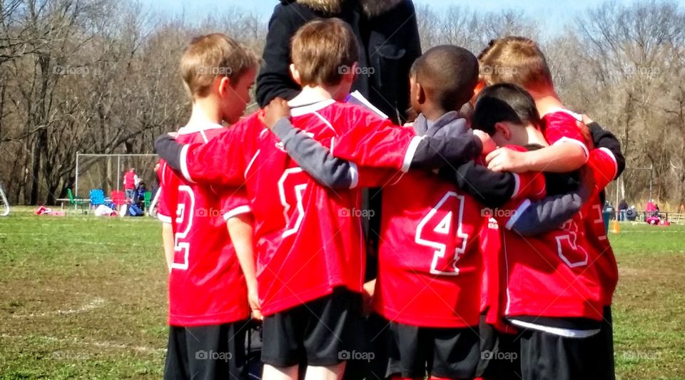 Soccer huddle. A kid's soccer team huddles up.