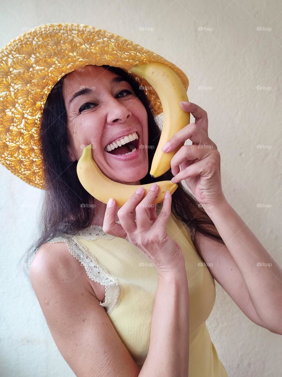 Funny Portrait of Beautiful Smiling Woman with bananas