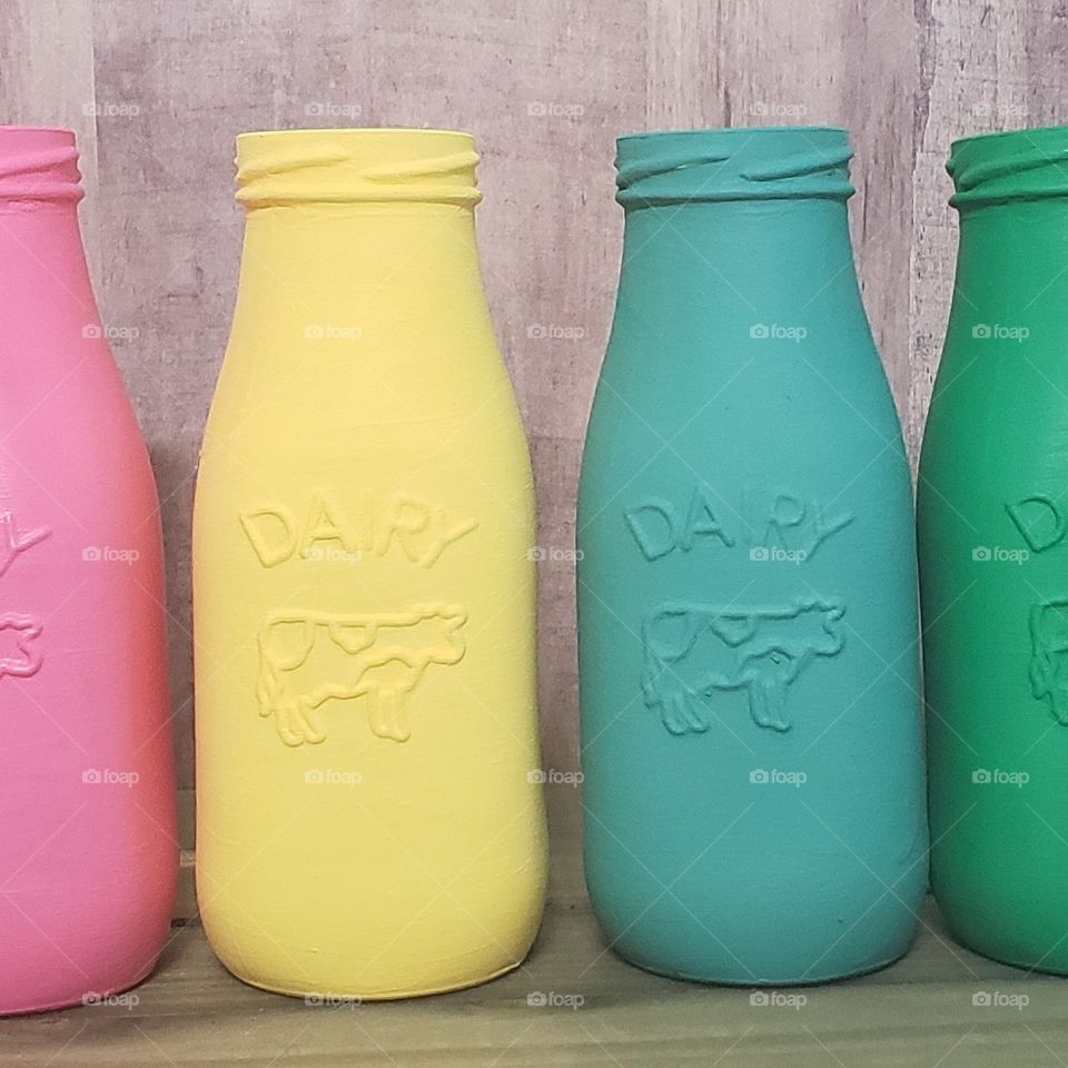 Colorful rainbow of dairy milk bottles