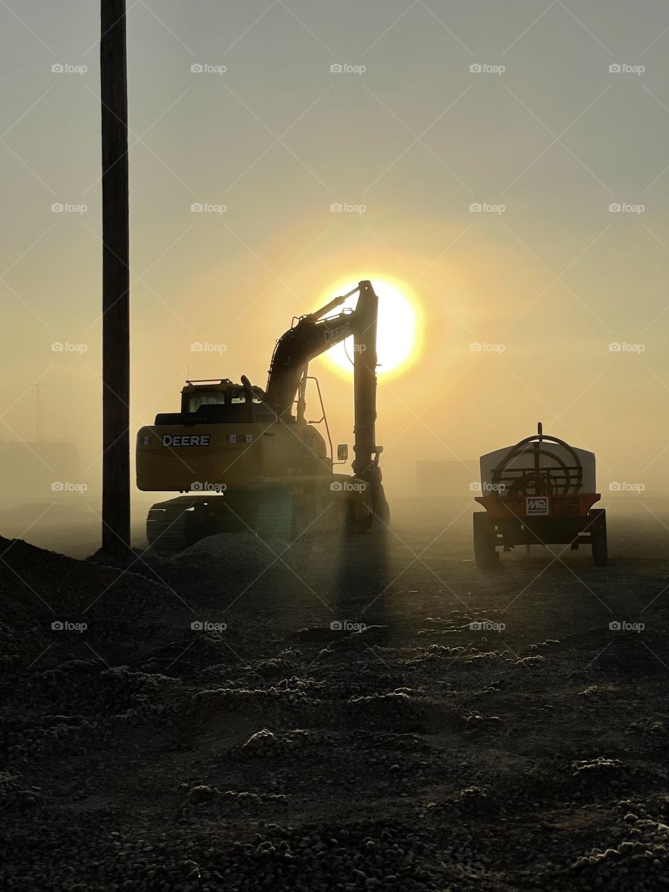 Early morning fog as the sun rises on the job site.
