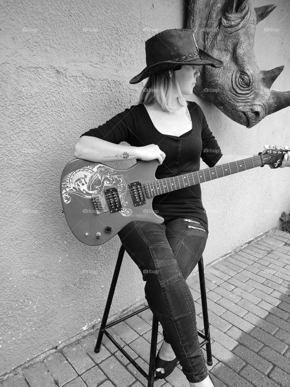 Female sitting with Electric Guitar