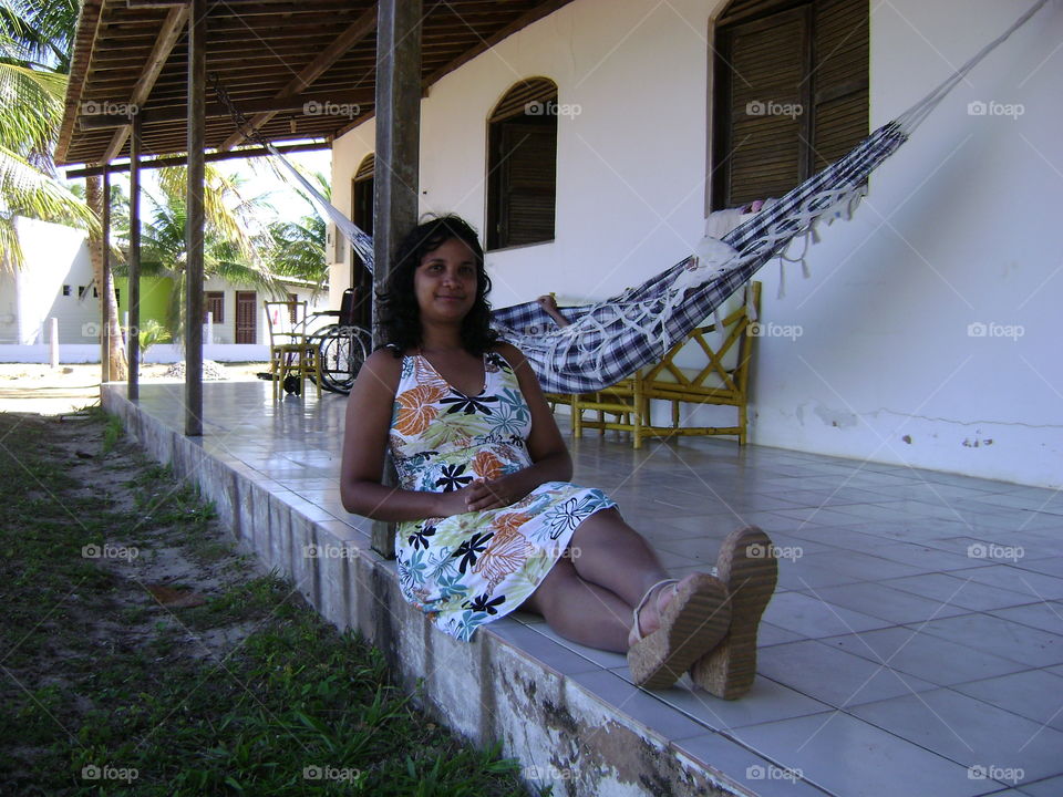 Woman relaxes at beach house.
