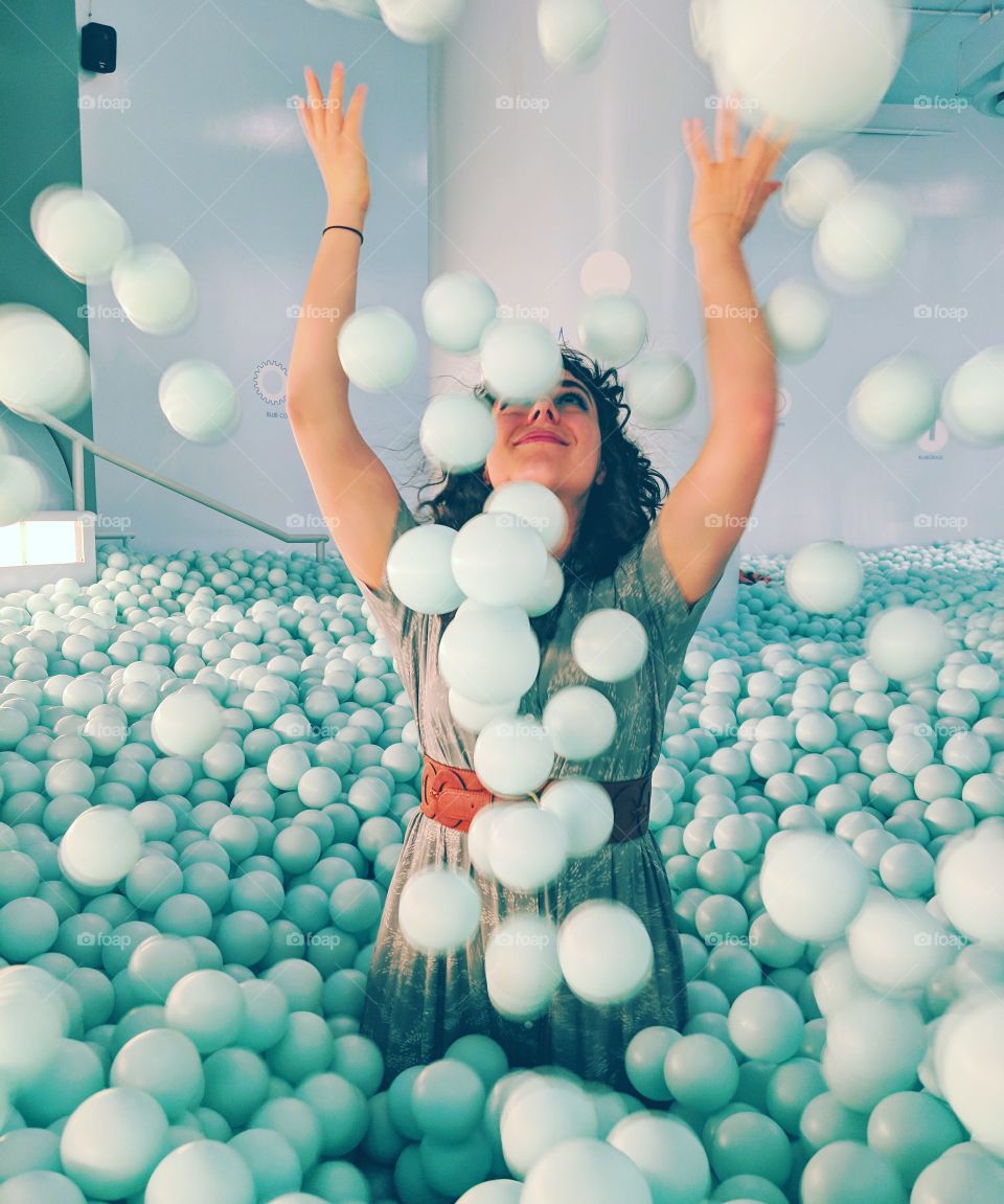 light blue balls thrown whimsically in air at color factory NYC