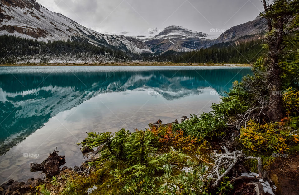 Mountain range reflected in bow lake