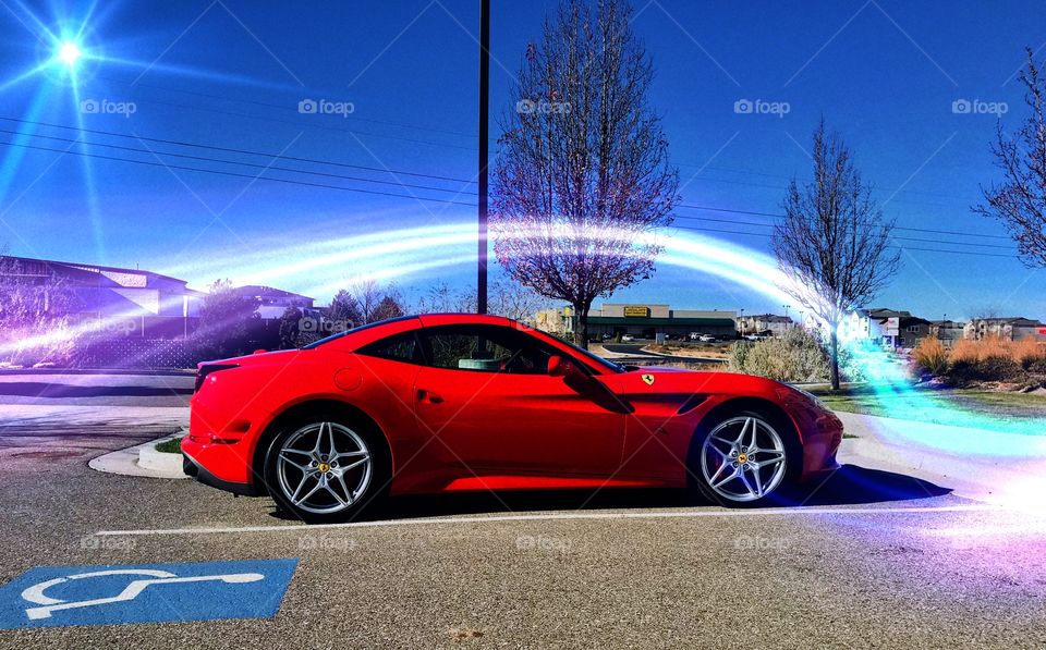 Ferrari in red. Gleaming in the sun light with light effects 