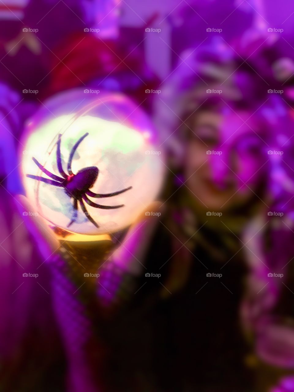 Random woman holding a sphere with a spider in it