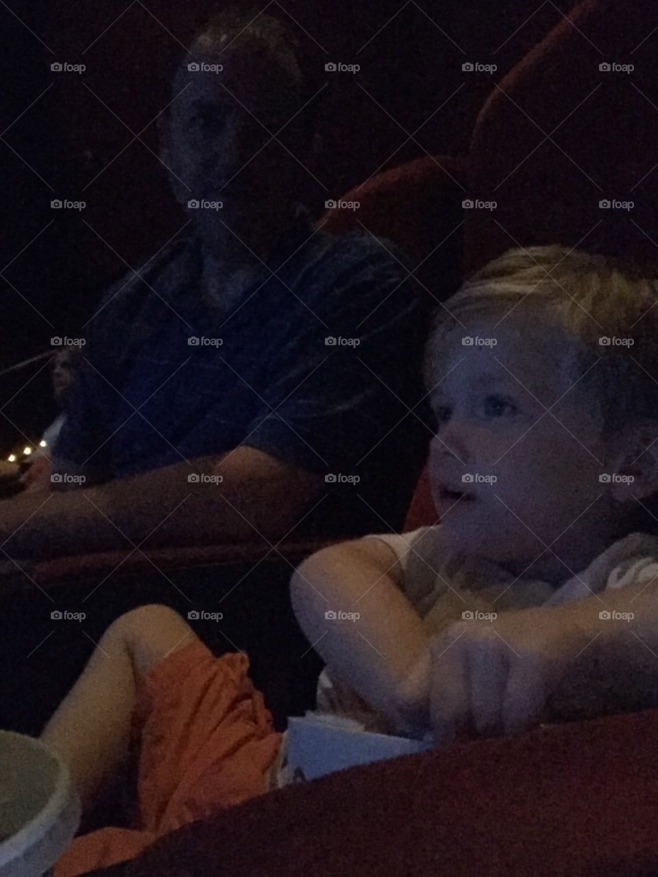 First night at the movies. Boy at his first movie with popcorn 