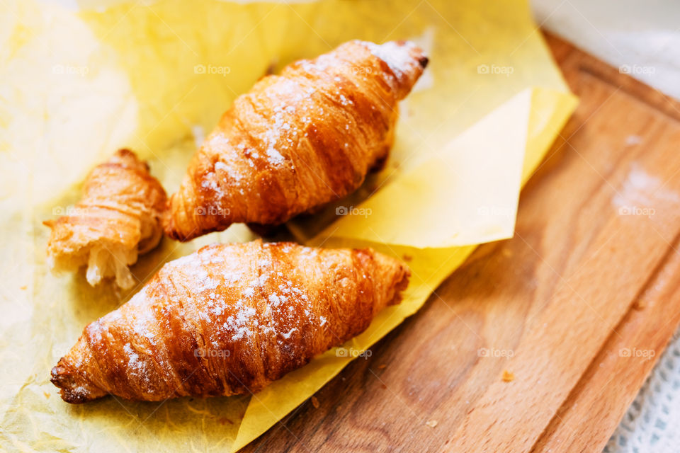 Fresh home baked croissant on wood board