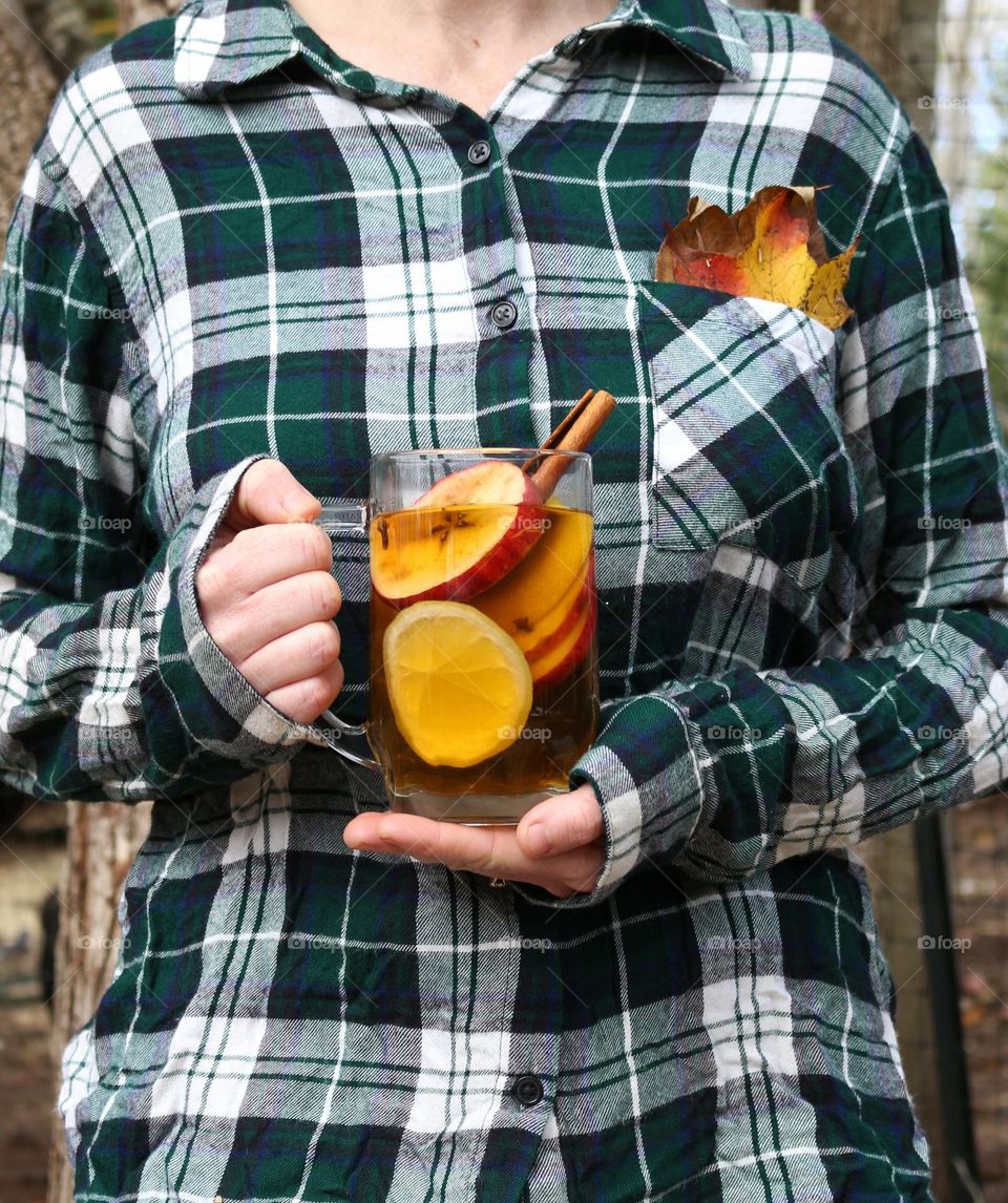 Holding a glass of homemade apple cider.