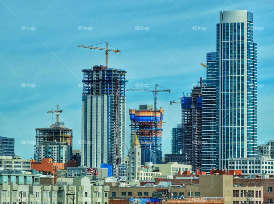Skyscrapers Under Construction On San Francisco Skyline. Construction Cranes Raising The City Skyline