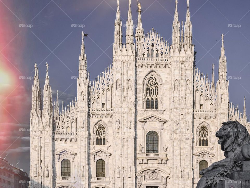 Milan cathedral and lion sculpture