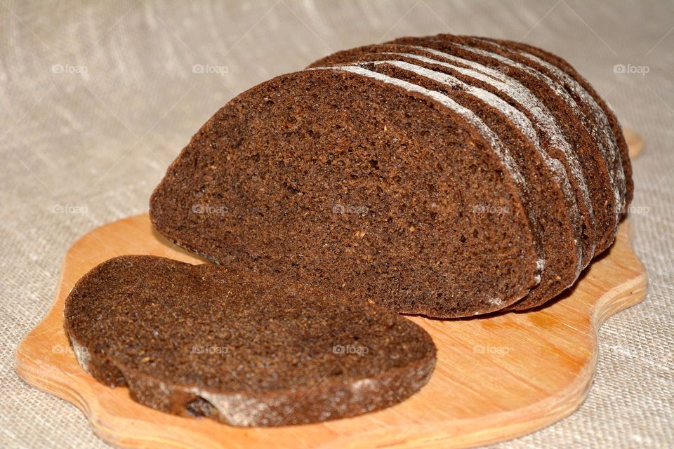 tasty healthy black bread on a wood board natural background