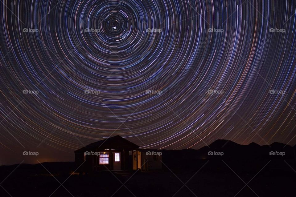Star trails over a house