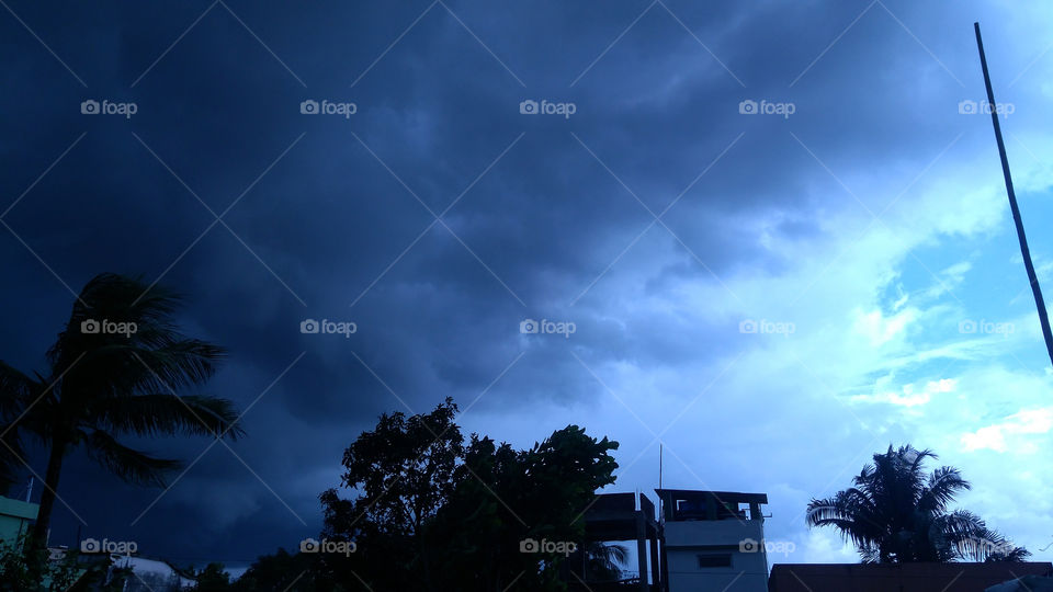 When the thick layers of dark clouds occupy the sky, if there is no wind at all to sweep them away.This photo was clicked by me this afternoon.Patch of blue in the sky, fighting to be seen through the clouds.Another secret of mother nature.
