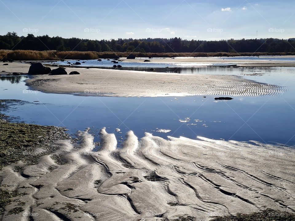 Pattern of sand on the sea on a clear sunny day