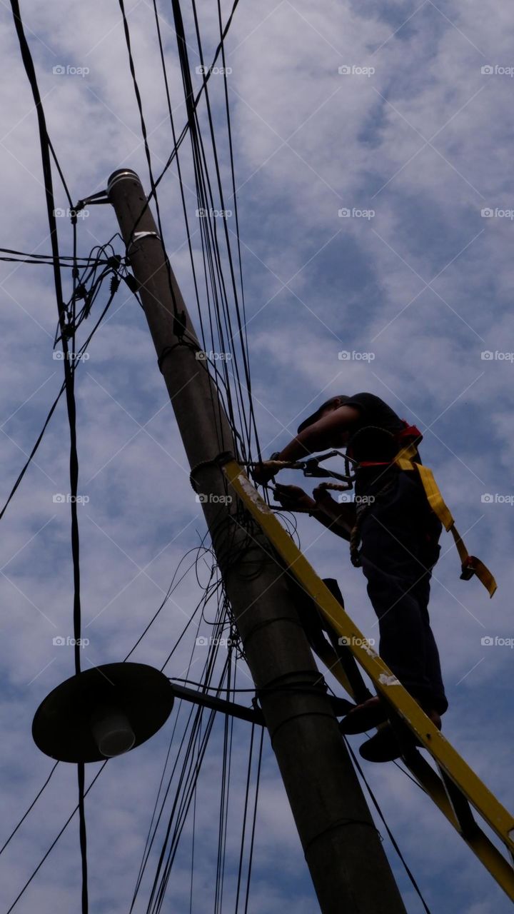 Human interest - A worker is repairing a street light