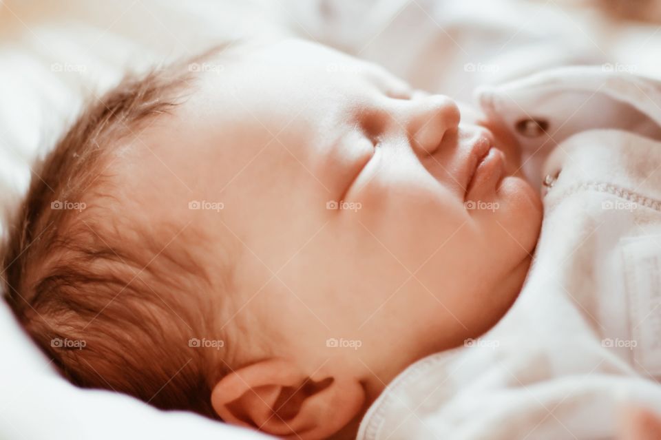 Baby boy sleeping on bed